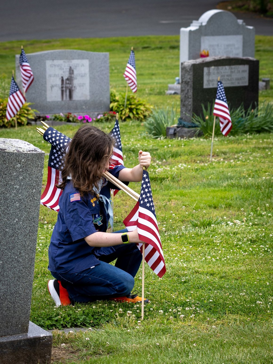 Scout placing Memorial Day flag